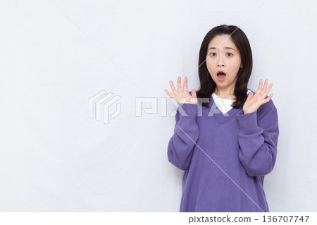 Surprised and amazed woman 136707747