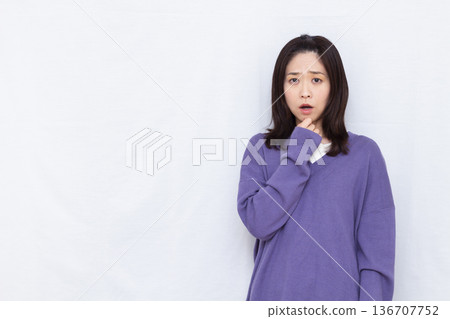 Surprised and amazed woman 136707752