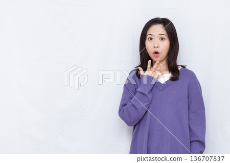 Surprised and amazed woman 136707837