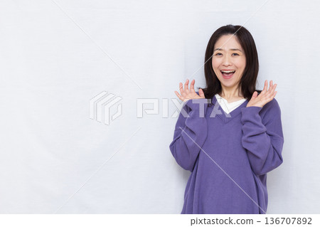 Smiling and surprised woman 136707892
