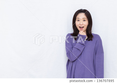 Smiling and surprised woman Smiling and surprised woman 136707895