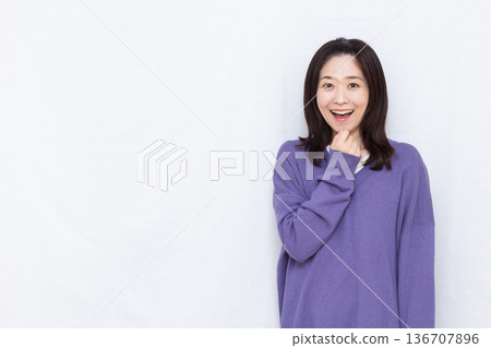Smiling and surprised woman Smiling and surprised woman 136707896