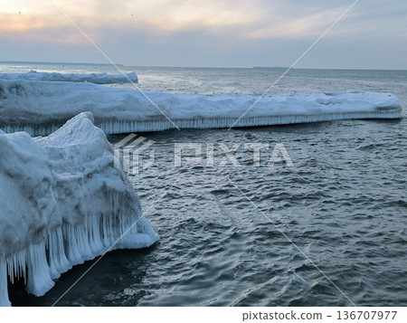 Snow- and ice-covered breakwaters in the Baltic Sea in winter 136707977