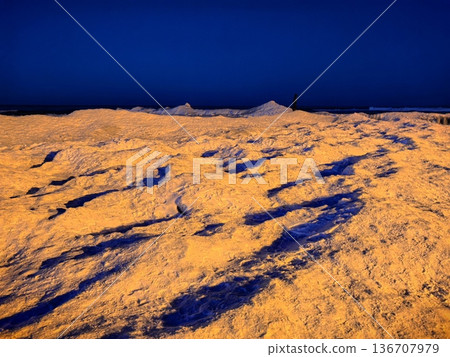 Snowy and icy shore, beautiful sunset on the Baltic Sea coast Snowy and icy shore, beautiful sunset on the Baltic Sea coast 136707979