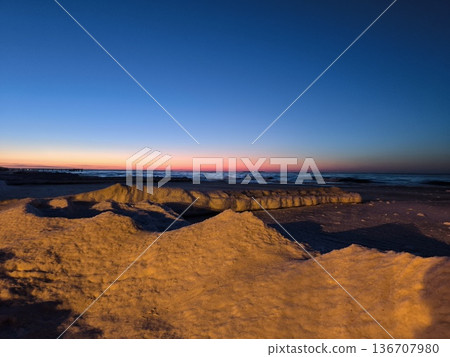 Snowy ice formations and a beautiful sunset on the Baltic Sea coast Snowy ice formations and a beautiful sunset on the Baltic Sea coast 136707980