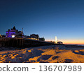 View of a coastal town from the frozen shore in winter at sunset 136707989