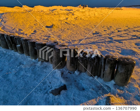 Wooden breakwaters frozen in ice and snow in the Baltic Sea Wooden breakwaters frozen in ice and snow in the Baltic Sea 136707990