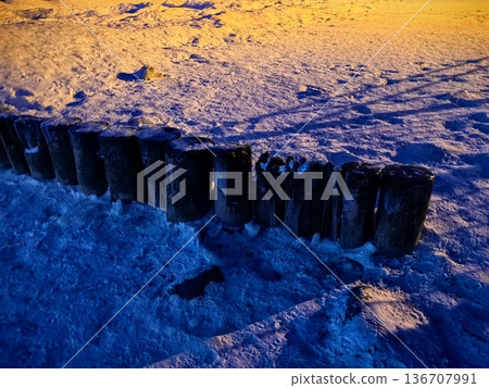 Wooden breakwaters in frozen water and snow in the Baltic Sea Wooden breakwaters in frozen water and snow in the Baltic Sea 136707991