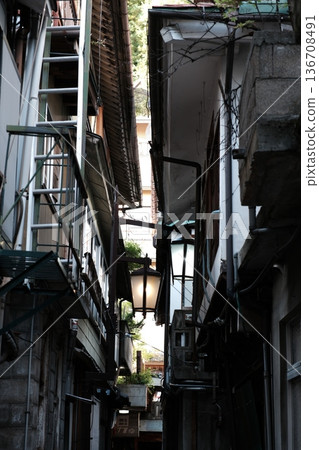 Telephoto composition of a densely packed narrow alley in Japan lit by lanterns 136708491