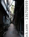 A narrow Japanese backstreet lined with wooden buildings 136708499
