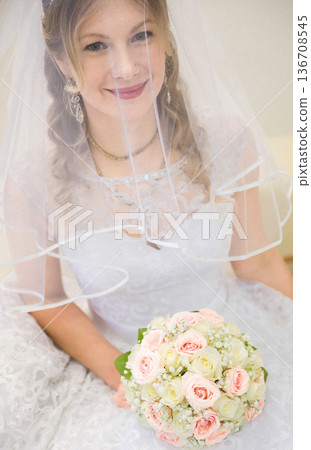 Smiling Bride Holding Wedding Bouquet Under Veil Smiling Bride Holding Wedding Bouquet Under Veil 136708545