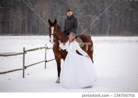 Winter Wedding Couple With Horse In Open Landscape Winter Wedding Couple With Horse In Open Landscape 136708708