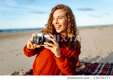 Happy woman with retro camera on the beach. Travel, weekend, relax and lifestyle concept. 136708777