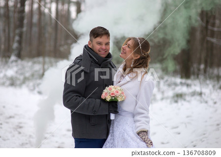 Joyful Wedding Couple Posing With Bouquet In Winter Joyful Wedding Couple Posing With Bouquet In Winter 136708809