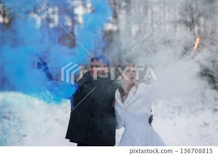 Winter Wedding Couple Celebrating With Blue And White Smoke Winter Wedding Couple Celebrating With Blue And White Smoke 136708815
