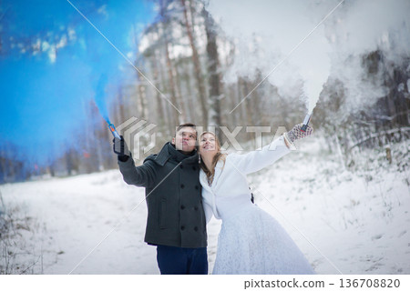 Winter Wedding Couple Celebrating With Blue And White Smoke 136708820