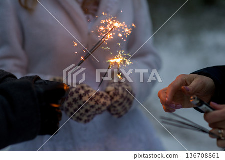Sparklers Glowing In Hands At Winter Wedding Sparklers Glowing In Hands At Winter Wedding 136708861