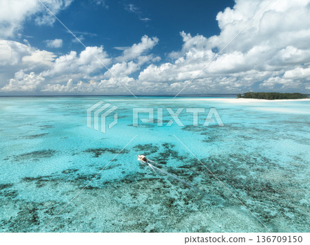 Aerial view of a boat in turquoise sea with transparent water 136709150