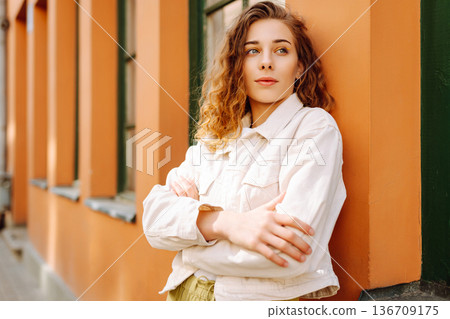 Outdoor portrait happy female tourist having good time wandering around town in summer Outdoor portrait happy female tourist having good time wandering around town in summer 136709175
