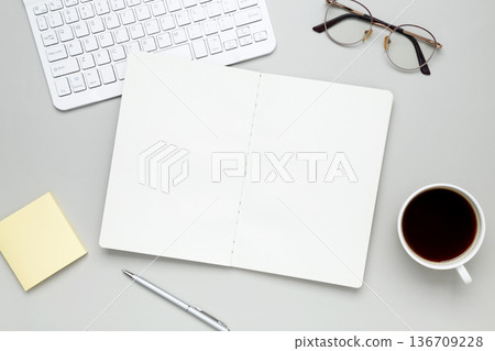 Organized workspace with stationery, keyboard, glasses and notebook creating productive atmosphere Organized workspace with stationery, keyboard, glasses and notebook creating productive atmosphere 136709228