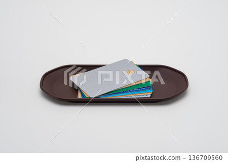 Many credit cards placed on a coin tray Many credit cards placed on a coin tray 136709560