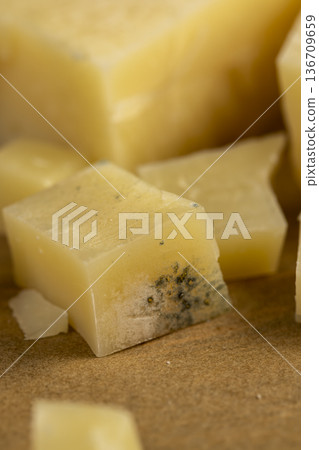 yellow rotting spoiled yellow cheese cut into pieces, covered with dangerous gray mold and mildew, spoiled cow's milk cheese , pieces of cheese for trash yellow rotting spoiled yellow cheese cut into pieces, covered with dangerous gray mold and mildew, spoiled cow's milk cheese , pieces of cheese for trash 136709659