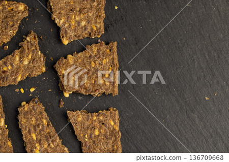 thin natural hard dry rye flour loaves with flax seeds and wheat fiber, natural healthy loaves from a complex of ingredients thin natural hard dry rye flour loaves with flax seeds and wheat fiber, natural healthy loaves from a complex of ingredients 136709668