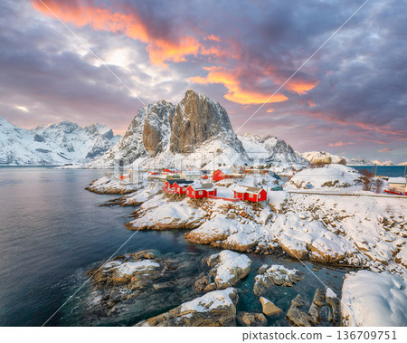 Captivating sunset winter view on Hamnoy village and Festhaeltinden mountain Captivating sunset winter view on Hamnoy village and Festhaeltinden mountain 136709751
