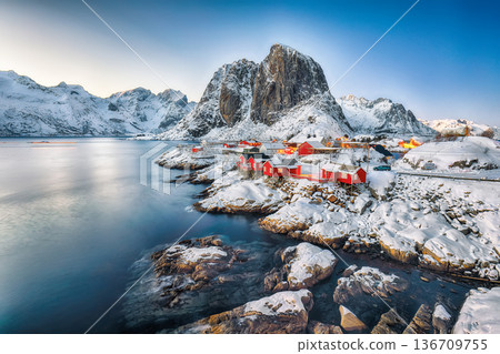 Captivating sunset winter view on Hamnoy village and Festhaeltinden mountain Captivating sunset winter view on Hamnoy village and Festhaeltinden mountain 136709755