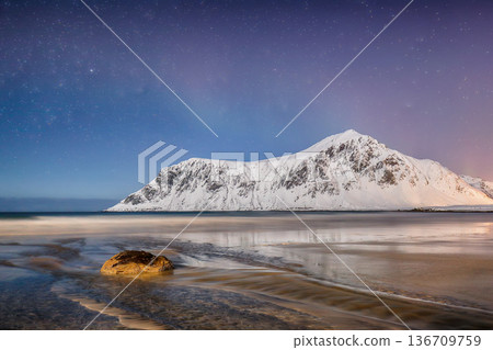 Captivating winter scenery on Skagsanden beach at night with starry sky. Captivating winter scenery on Skagsanden beach at night with starry sky. 136709759