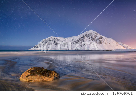 Captivating winter scenery on Skagsanden beach at night with starry sky. Captivating winter scenery on Skagsanden beach at night with starry sky. 136709761