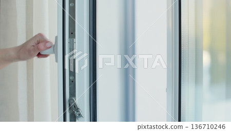 Close-up young woman opening window to refresh room. Close-up young woman opening window to refresh room. 136710246