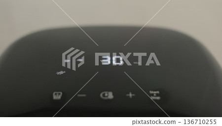 Air fryer cooking with timer counting on the screen. Smart device at home kitchen. Healthy food for diet eating. Air fryer cooking with timer counting on the screen. Smart device at home kitchen. Healthy food for diet eating. 136710255