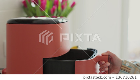 Modern air fryer in kitchen - concept of preparing a healthy food. Smart device at home kitchen. 136710261