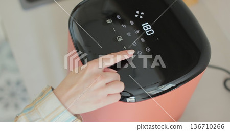 Cooking onion rings in the air fryer. Healthy food for diet eating. Cooking onion rings in the air fryer. Healthy food for diet eating. 136710266