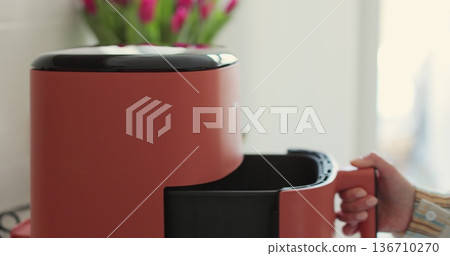 Close-up of air fryer in kitchen - concept of preparing a healthy dessert. Smart device at home kitchen. Close-up of air fryer in kitchen - concept of preparing a healthy dessert. Smart device at home kitchen. 136710270