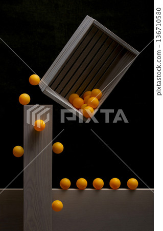 Geometric still life with a wooden box and orange balls 136710580