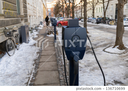 Public electric vehicle charging station in winter street Public electric vehicle charging station in winter street 136710699