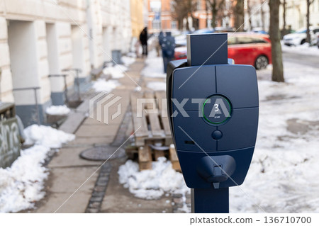 Public electric vehicle charging station in winter street Public electric vehicle charging station in winter street 136710700