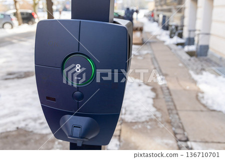 Public electric vehicle charging station in winter street Public electric vehicle charging station in winter street 136710701