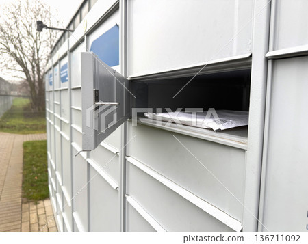 Modern mailbox system receiving online shopping parcel. 136711092