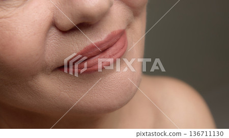 Close up mature woman lips with natural makeup Close up mature woman lips with natural makeup 136711130