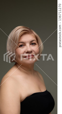 Mature woman short blonde hair natural beauty studio portrait. 136711270