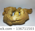 Fresh ginger root resting on a clean white surface. 136711503