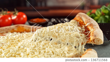 Closeup of a freshly baked pizza with melted cheese and golden crust in warm, appetizing light. Classic comfort food concept with rich texture and inviting presentation. Closeup of a freshly baked pizza with melted cheese and golden crust in warm, appetizing light. Classic comfort food concept with rich texture and inviting presentation. 136711568