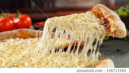 Closeup of a freshly baked pizza with melted cheese and golden crust in warm, appetizing light. Classic comfort food concept with rich texture and inviting presentation. Closeup of a freshly baked pizza with melted cheese and golden crust in warm, appetizing light. Classic comfort food concept with rich texture and inviting presentation. 136711569