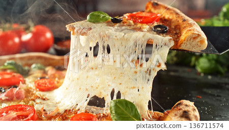 Closeup of a freshly baked pizza with melted cheese and golden crust in warm, appetizing light. Classic comfort food concept with rich texture and inviting presentation. 136711574