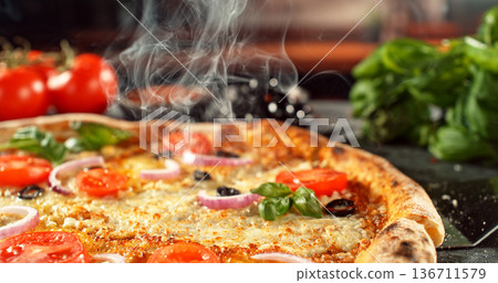 Closeup of a freshly baked pizza with melted cheese and golden crust in warm, appetizing light. Classic comfort food concept with rich texture and inviting presentation. 136711579