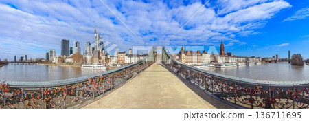 Iron footbridge with Frankfurt skyline over river Main Iron footbridge with Frankfurt skyline over river Main 136711695