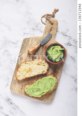 Ciabatta with avocado pasta, breakfast, on a chopping board, top view, homemade, no people, 136711948